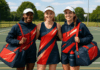Australian netball uniforms on three female netball players wearing custom hats.