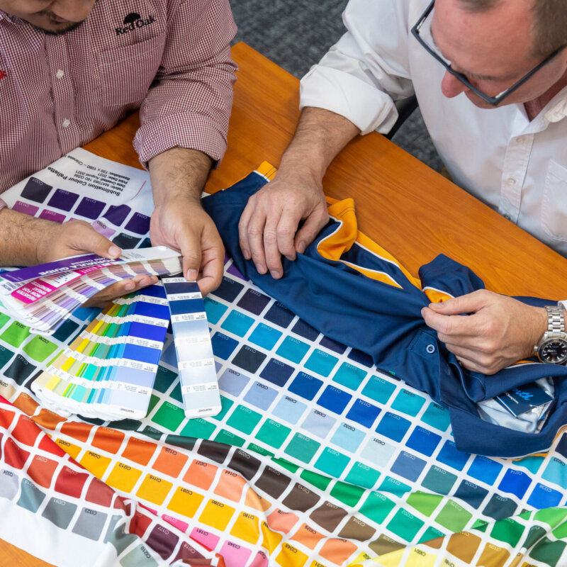 Uniform Link team looking at fabric types and sublimation colours
