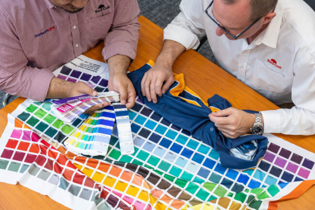 Uniform Link team looking at fabric types and sublimated colours Uniform Link team looking at fabric types and sublimation colours