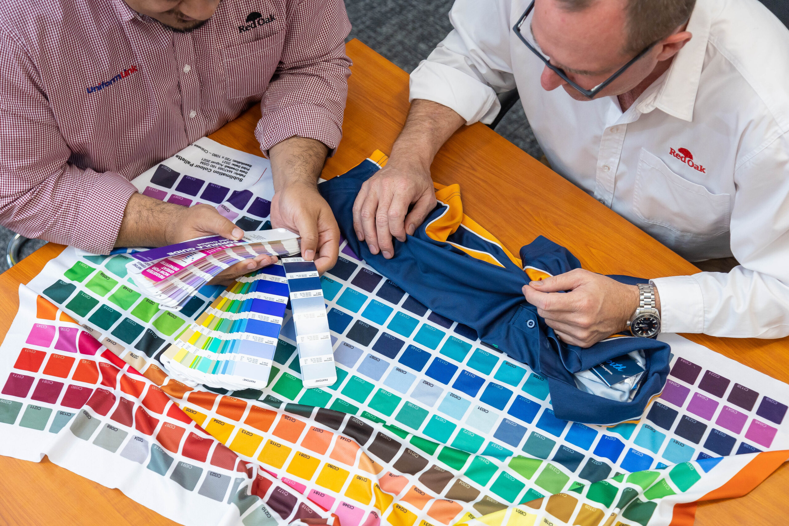 Uniform Link team looking at fabric types and sublimated colours Uniform Link team looking at fabric types and sublimation colours